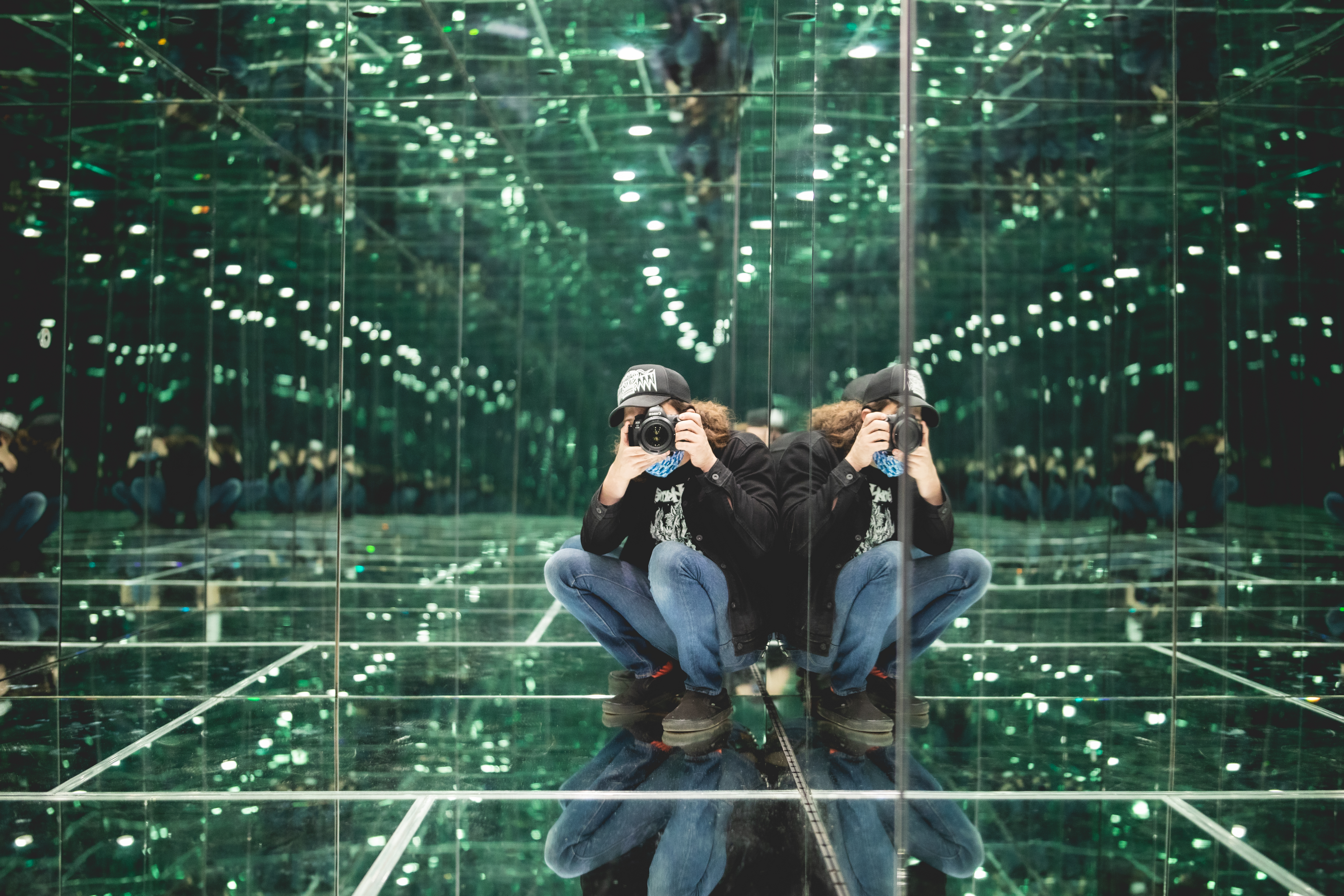 Mirrored Inception Cube interior with green points of light