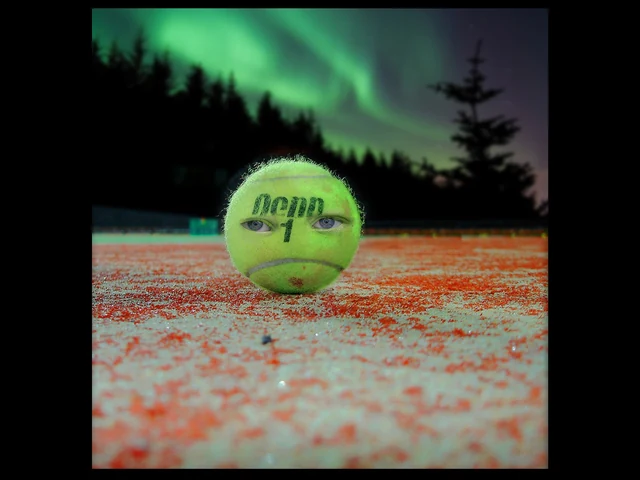 Tennis ball beneath the aurora